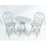 An oval garden table and two chairs (3).