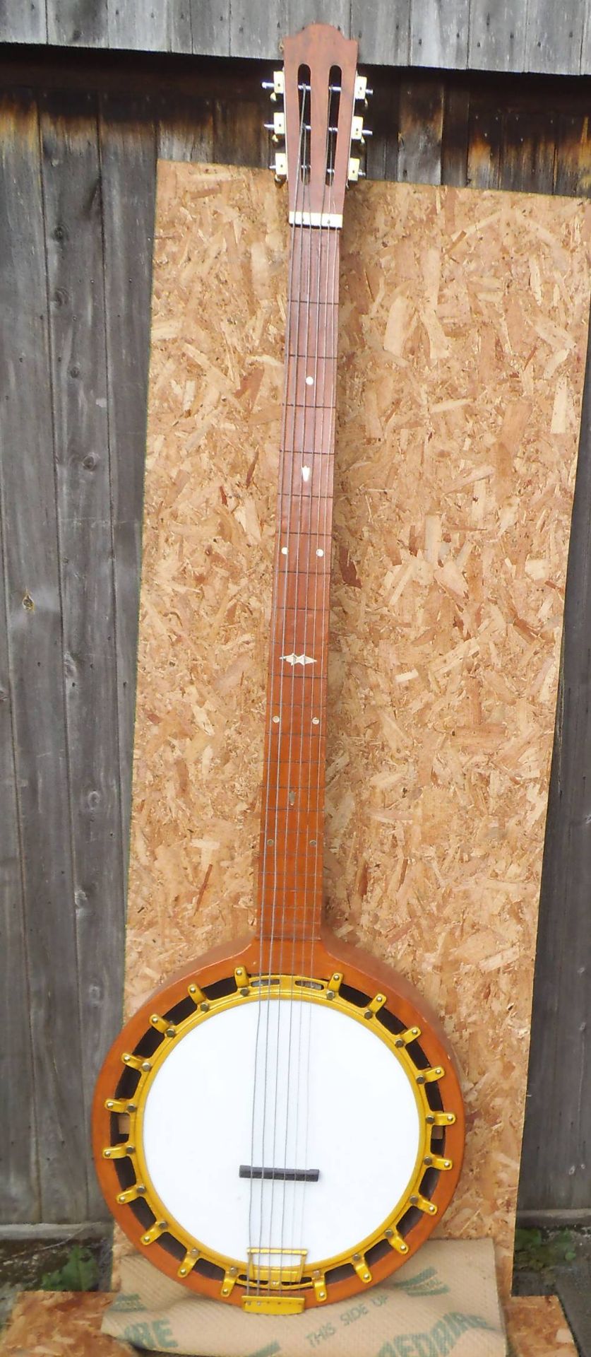 A large scale model of a banjo, 260 x 77 x 18cm.