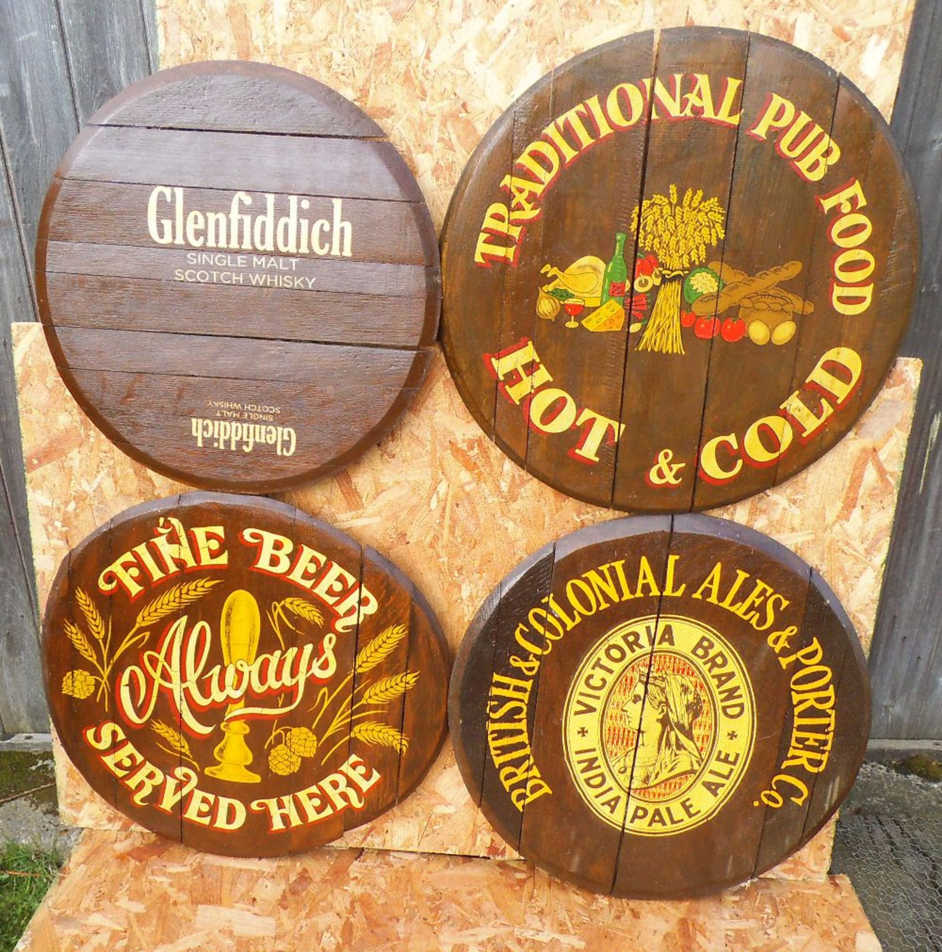 Four reproduction painted oak barrel lids, diameter 60cm.