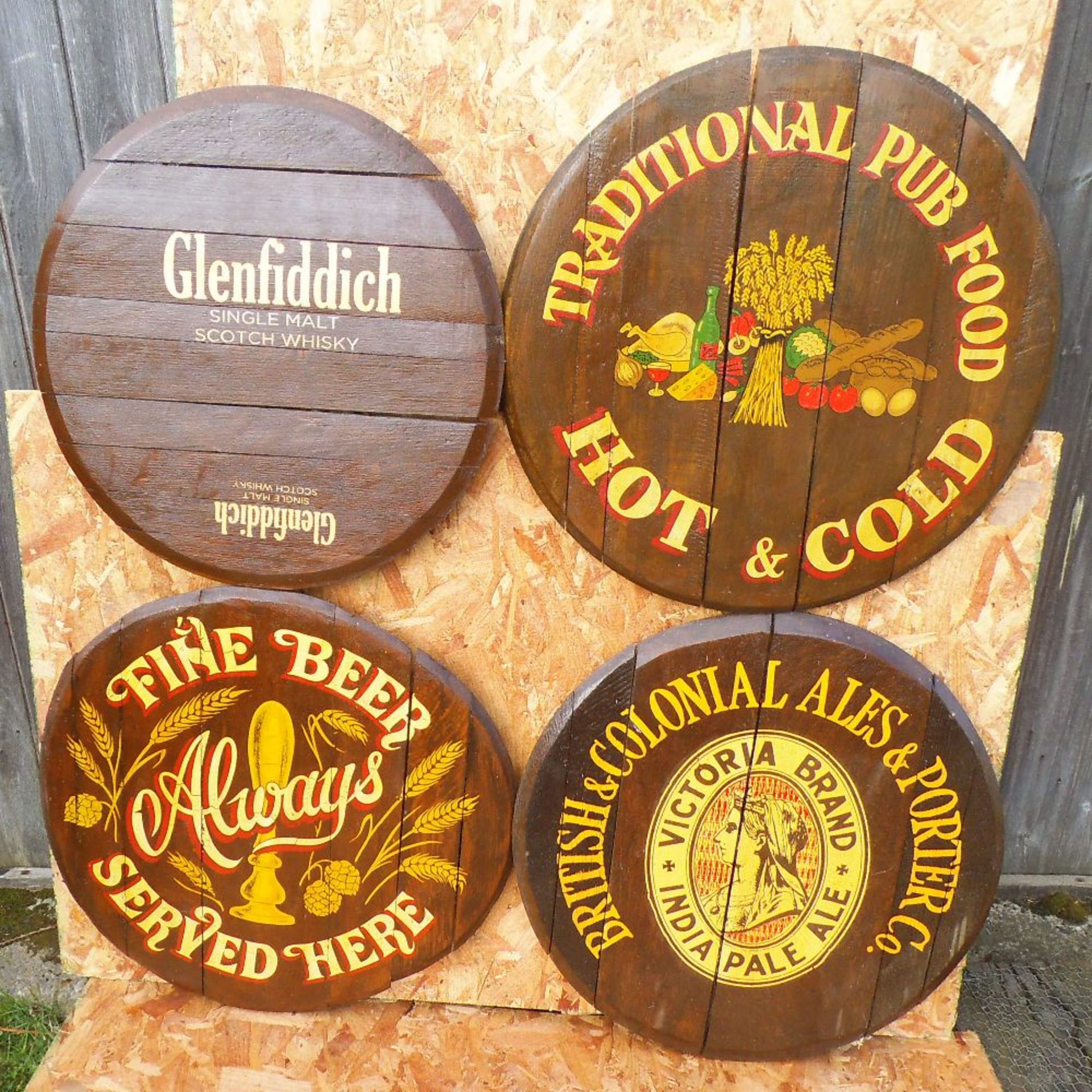 Four reproduction painted oak barrel lids, diameter 60cm.
