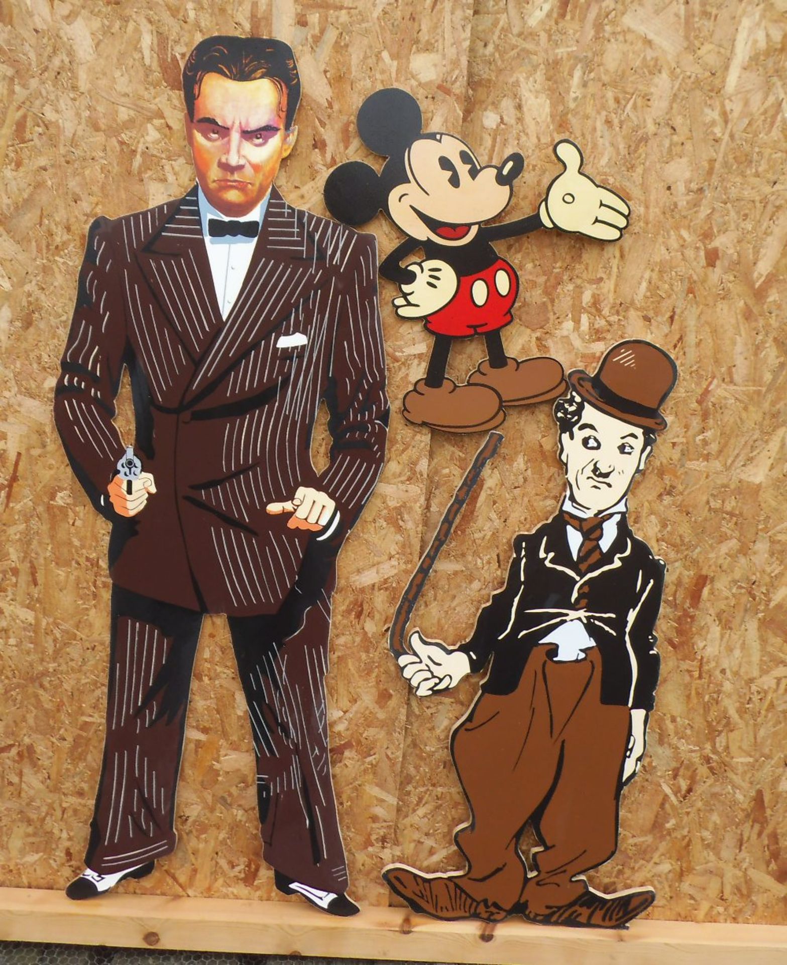 Three wooden cut outs, Cagney, Charlie Chaplin & Mickey Mouse, height, 162, 120 & 59cm.