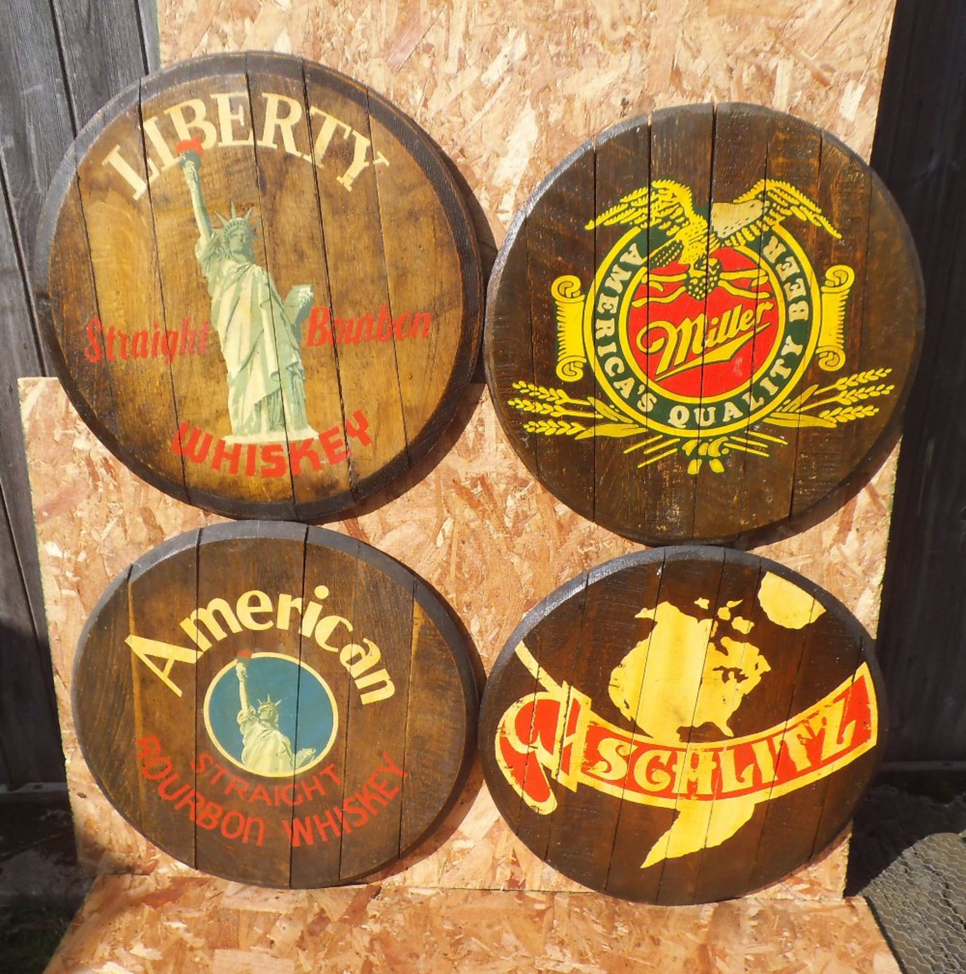Four reproduction American themed oak barrel lids, diameter 60cm.