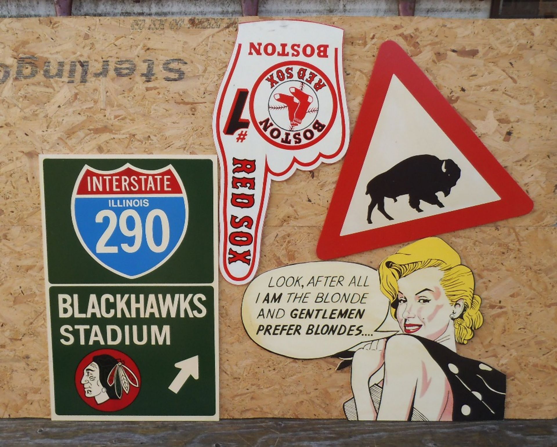 Four reproduction wooden signs, Blackhawks height 81cm.