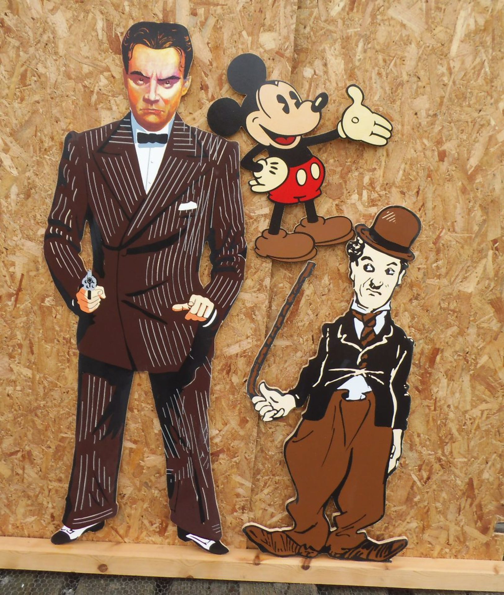 Three wooden cut outs, Cagney, Charlie Chaplin & Mickey Mouse, height, 162, 120 & 59cm.