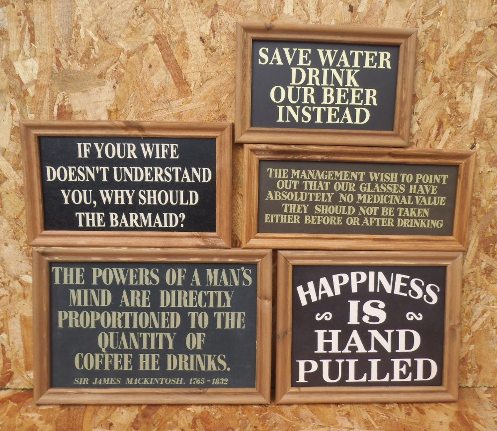 Five humorous wooden bar signs, framed. 'Happiness is hand pulled' width 36cm.