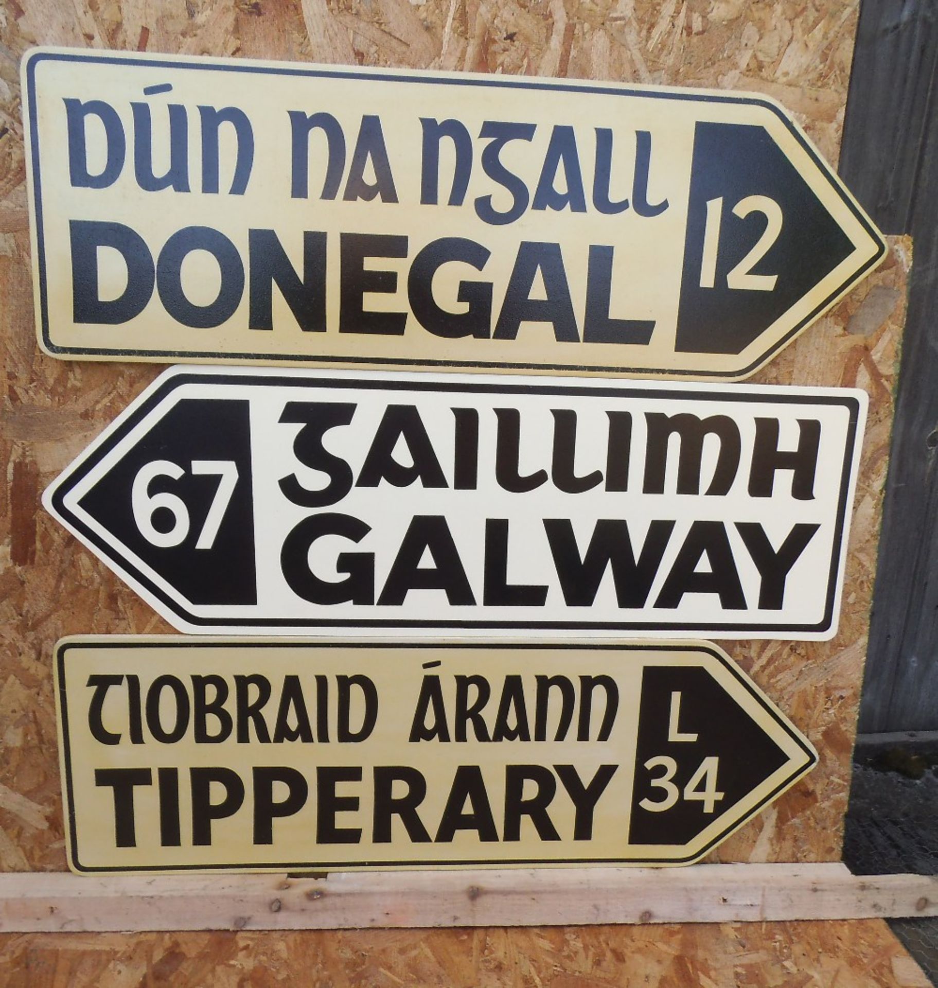 Three replica wooden Irish road signs, 90 x 30cm.