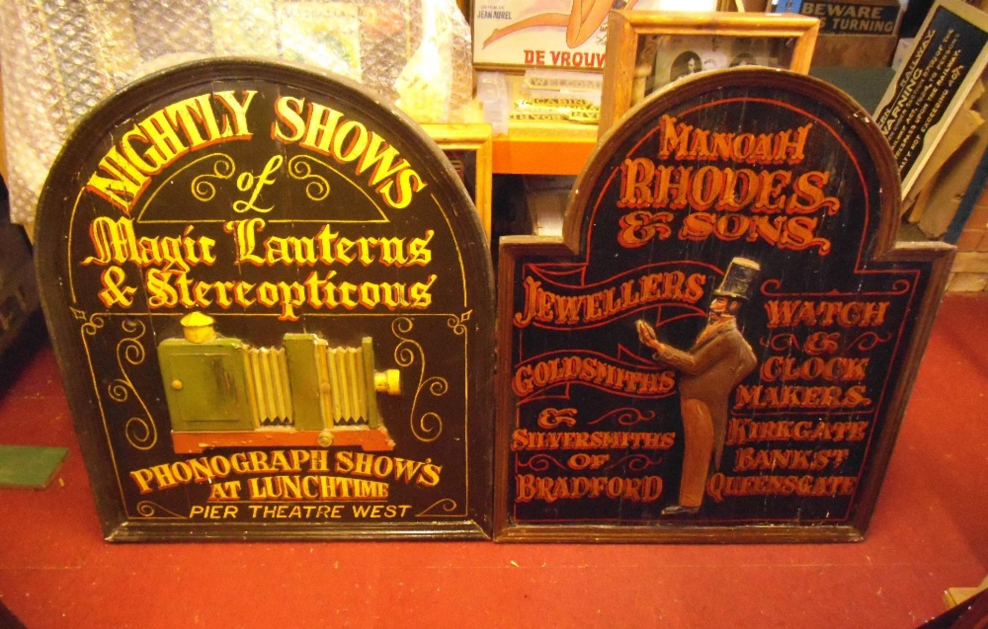 Two reproduction wooden shop signs, Bradford jewellers and a magic lantern show, 91 x 76cm (2).