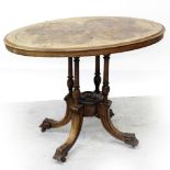 A small Victorian walnut oval table with line inlay, on quadripartite birdcage base, length 91.5cm.