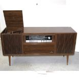 A c1960s walnut veneered Grundig radiogram with tuner and record player, width 145cm.