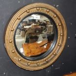 A gilt and ebonised convex captain's mirror, diameter 43cm.