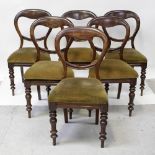 A set of six Victorian mahogany balloon-back chairs with pin-stuffed seats supported on turned