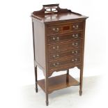An Edwardian mahogany five-drawer music cabinet with galleried top supported on square tapering