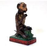 An original late 19th century novelty cast iron money bank modelled a monkey with coconut,