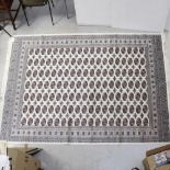 A modern beige ground Bokhara carpet, 300 x 200cm.