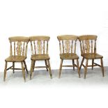 A set of four pine Victorian-style kitchen chairs with vase splats over plank seats,