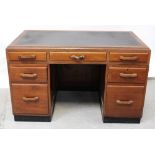 A mid-20th century mahogany kneehole office desk,