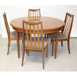 A G-plan oval dining table, of circular form when condensed and supported on turned tapering legs,