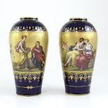 A pair of 19th century Vienna porcelain baluster vases decorated with hand-painted and raised gilt