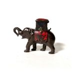 An original late 19th century novelty cast iron money bank modelled as an Indian elephant with