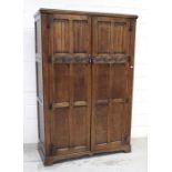 An early/mid-20th century Waring & Gillow oak wardrobe in the Colonial style,