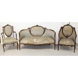 An Edwardian mahogany three-piece salon suite comprising sofa and two chairs,