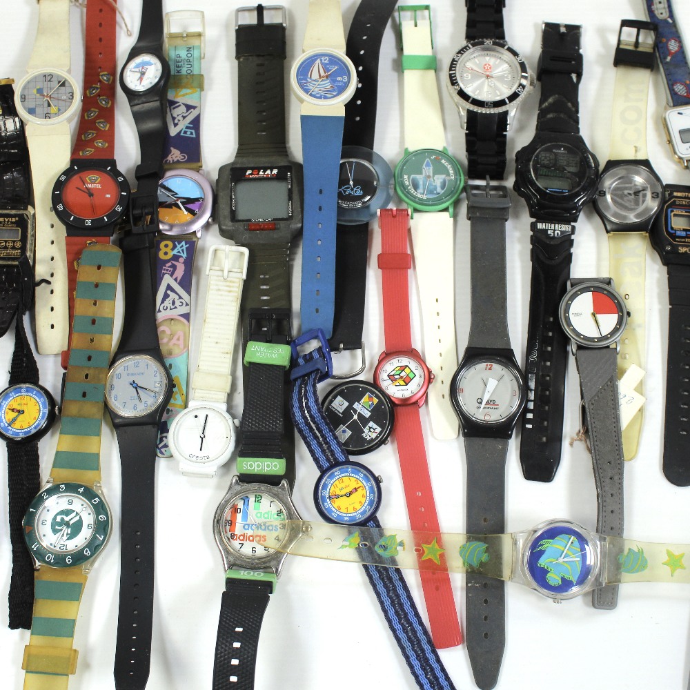 A large collection of analogue and digital Quartz wristwatches, mainly advertising examples.