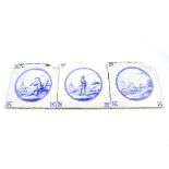 A pair of 18th century Dutch Delft blue and white ceramic tiles depicting scenes of shepherds and