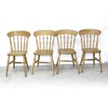 A set of four Victorian-style beech kitchen chairs with plank seat and turned legs united by an