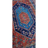 An antique Persian hand-made Behbahan rug, 202 x 135cm (af).