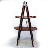 An Edwardian mahogany fold-up cake stand, height 95cm.