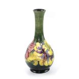 A Moorcroft blue-green ground baluster vase with tube-lined multicoloured decoration of hibiscus,