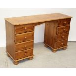 A modern yellow pine pedestal dressing table with two banks of four drawers united by a plank top,