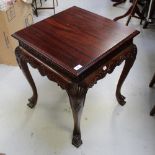 A modern mahogany reproduction silver table with incised carved frieze and supported on carved