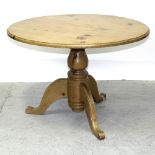 A modern pine circular dining table on tripartite pedestal base, diameter 105.5cm.