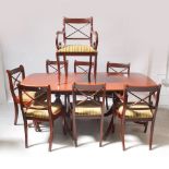 A 20th century mahogany reproduction twin-pillar dining table on tripartite pedestal base,