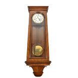 A late 19th century walnut Vienna style twin weight wall clock with circular dial set with Arabic