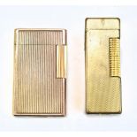 A Dunhill gold plated lighter and a Dupont example (2).