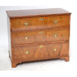A walnut feather strung and cross banded chest of three long drawers raised on bracket feet, width