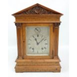 A late 19th century satin walnut mantel clock with architectural stepped case, rectangular