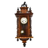 A small Vienna style spring driven walnut and stained beech wall clock with white enamel dial set