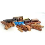 A cast iron miniature cannon, length 43cm (lacking stand), further wooden model cannons and