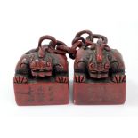 A Chinese carved hard stone double seal, each square section decorated with a carved mythical beast,