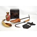 An Oriental black lacquered small table cabinet, a shoe stretcher, horn, a cast iron plaque,