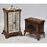 A cast iron stove in white and brown, height approx 91cm (af, lid fittings loose) and a smaller