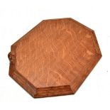 ROBERT THOMPSON OF KILBURN; a Mouseman oak bread or cheeseboard of octagonal form bearing