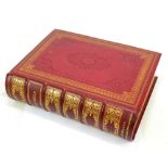 A Victorian family bible printed by Collins, in gilt tooled red leather bindings.
