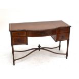 An Edwardian mahogany satinwood banded and inlaid writing desk of shaped outline with five drawers