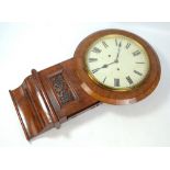 A late 19th century walnut and figured walnut drop dial wall clock set with Roman numerals above