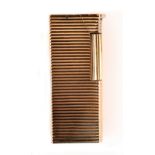 DUNHILL; "The Aldunil", a silver and rose gold plated lighter of ribbed rectangular form, stamped '