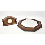 An early 20th century oak mantel clock with shaped case and painted dial, width 27cm, also an